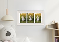 a child's room with a teddy bear and framed pictures